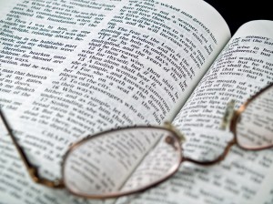The Bible opened to the Book of Proverbs with Glasses