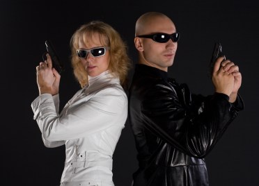 Man and women with guns on black